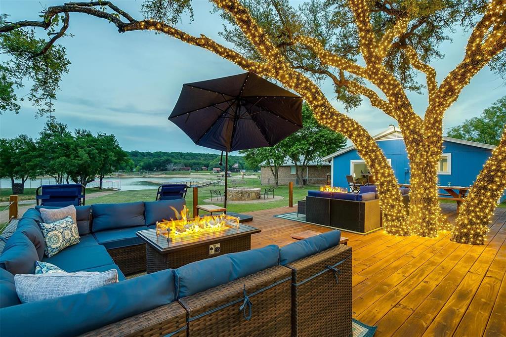 520 Deer Trail Gordon, TX 76453 - Photo 31 of 40 Deck featuring an outdoor living space with a fire pit and a water view