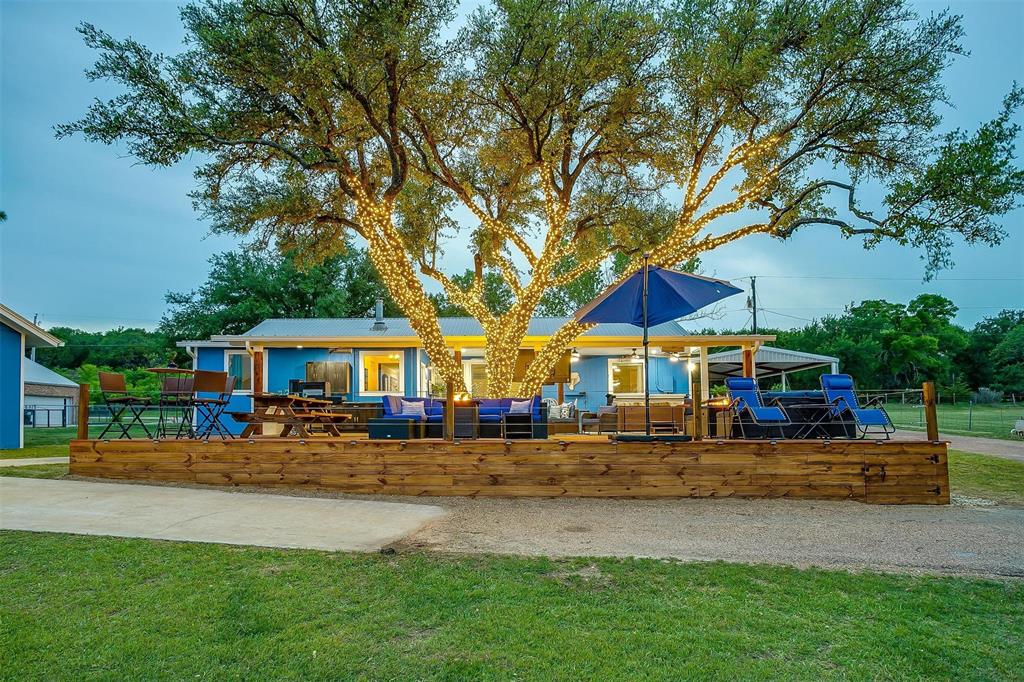 520 Deer Trail Gordon, TX 76453 - Photo 33 of 40 View of jungle gym with a wooden deck and a lawn