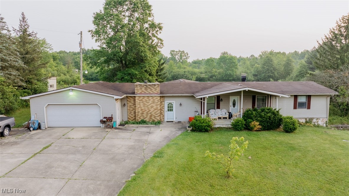 16510 Mock Road Berlin Center, OH 44401 - Photo 26 of 29 Ranch-style home featuring a garage, a front yard, concrete driveway, a chimney, and covered porch
