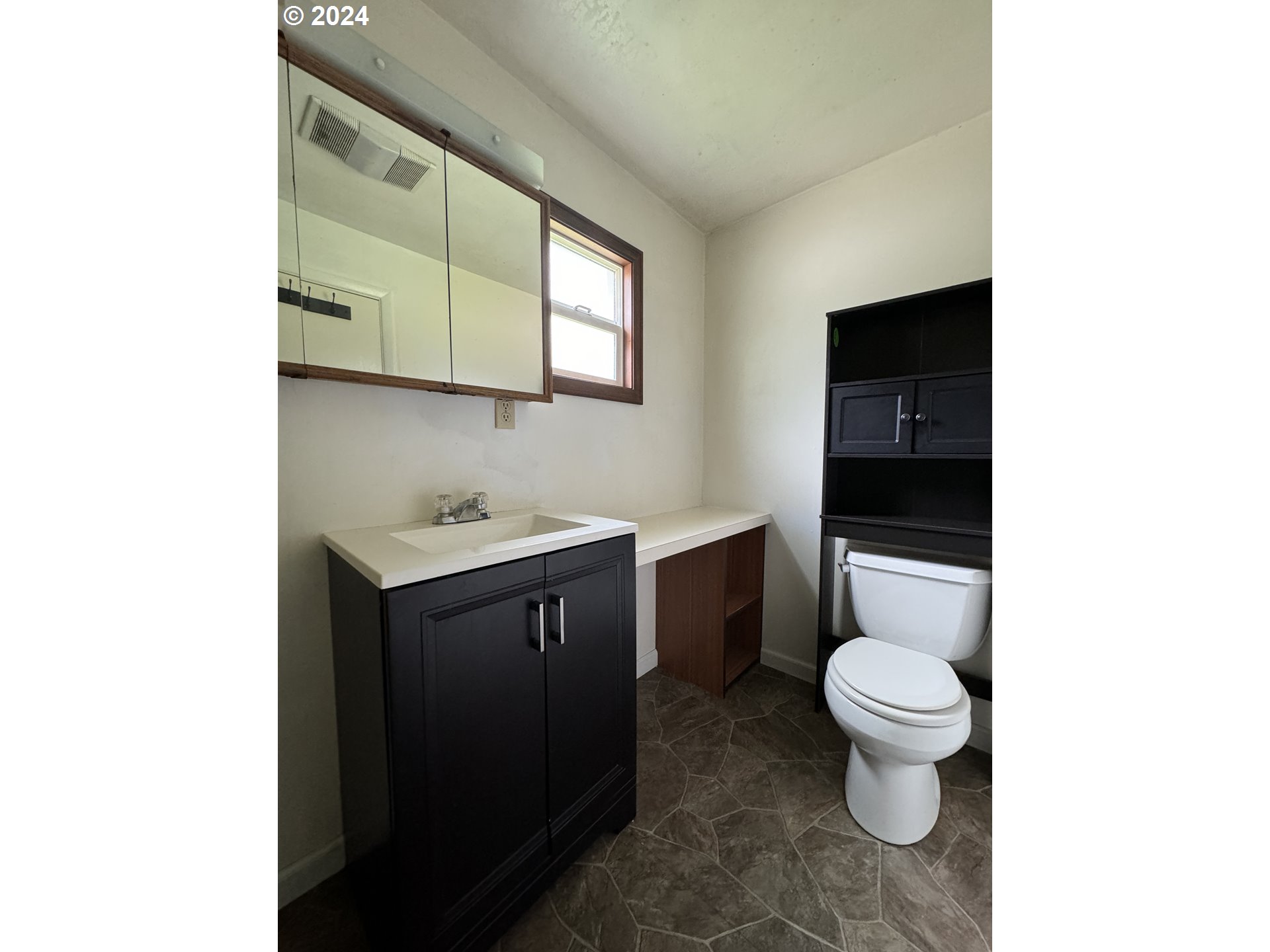 210 Winter Green Drive Riddle, OR 97469 - Photo 11 of 30 a bathroom with a granite countertop toilet sink and mirror