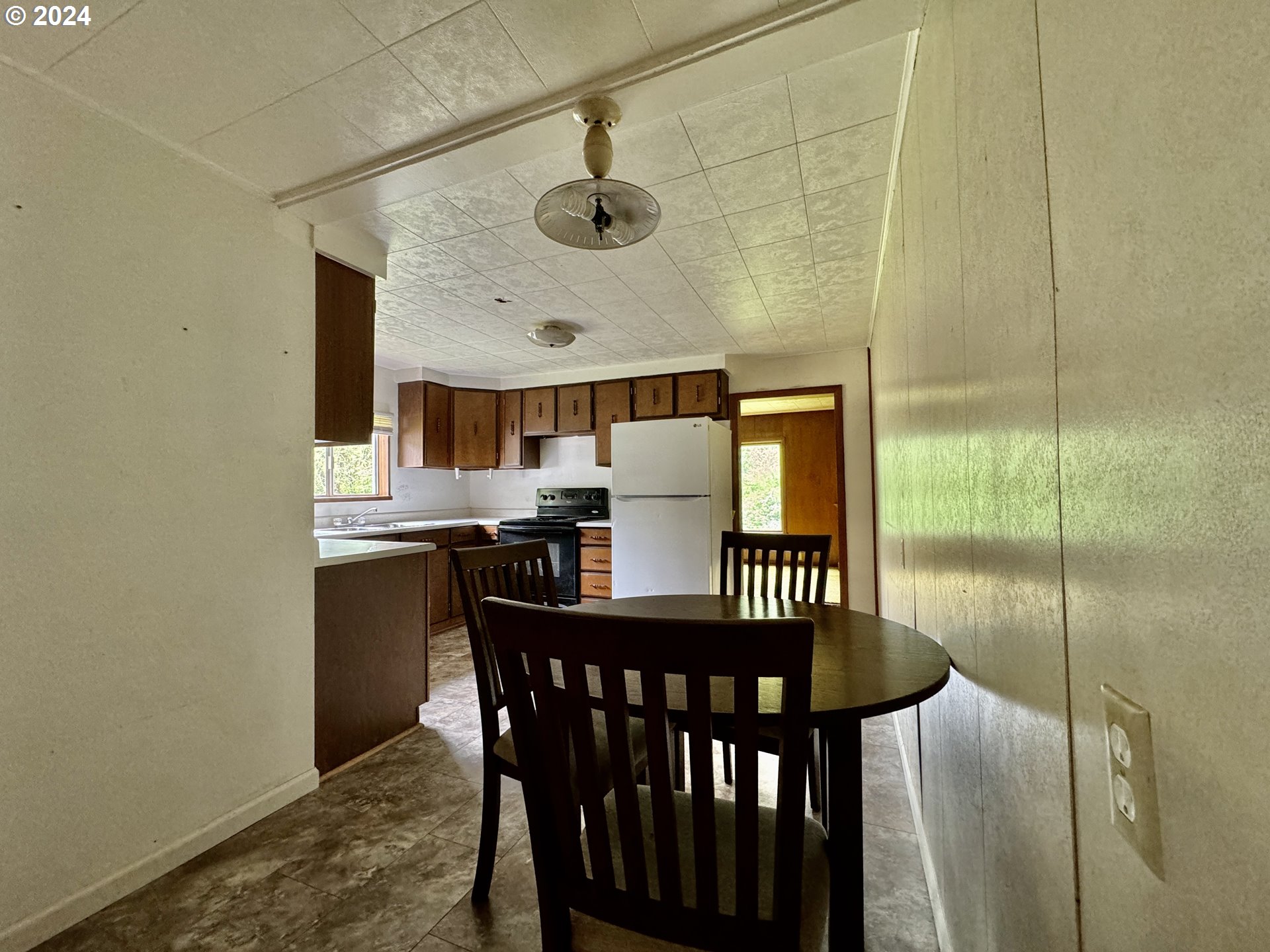 210 Winter Green Drive Riddle, OR 97469 - Photo 14 of 30 a view of a dining room with furniture window and wooden floor