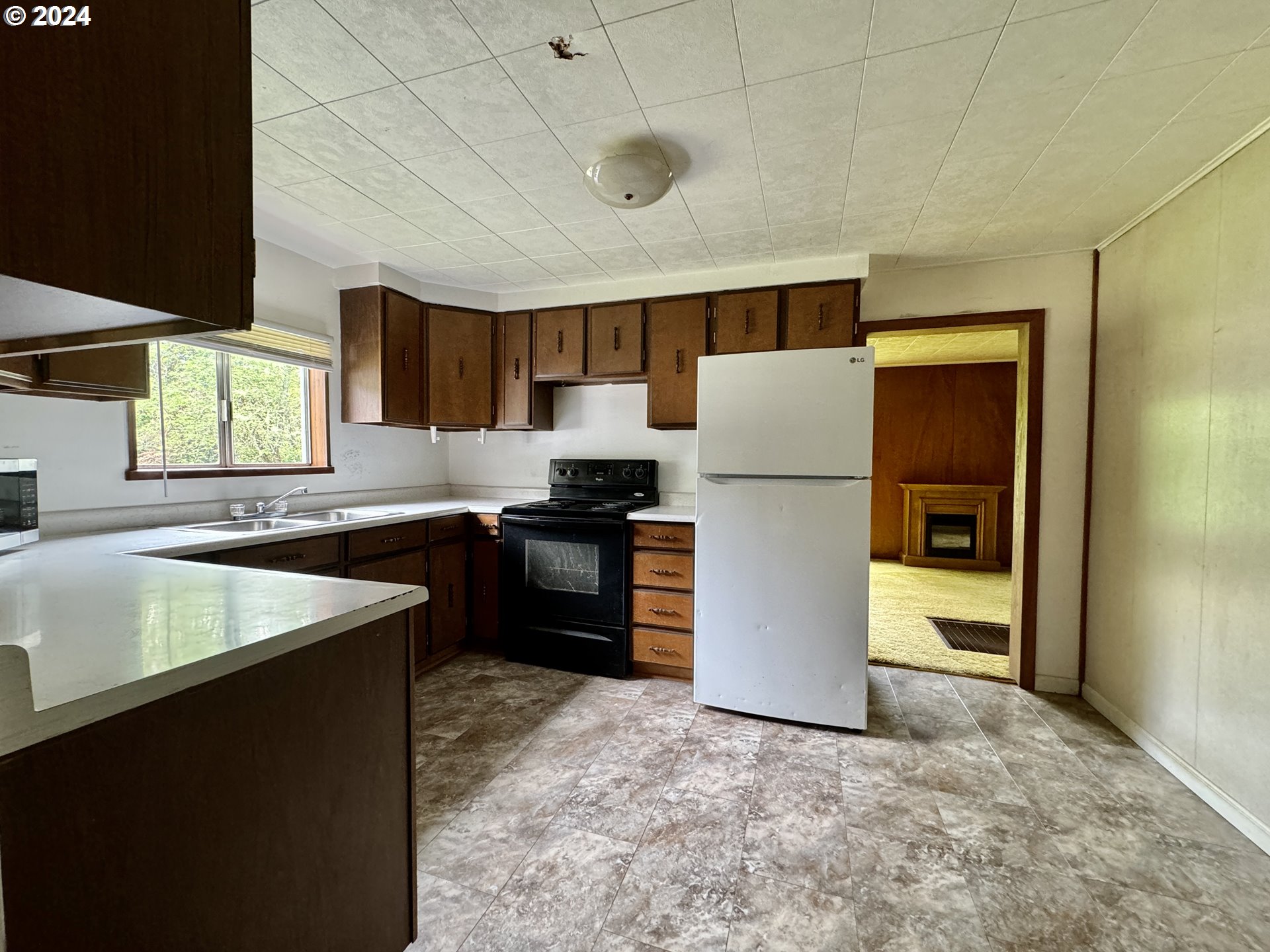 210 Winter Green Drive Riddle, OR 97469 - Photo 15 of 30 a kitchen with a refrigerator a stove top oven a sink and dishwasher with wooden floor