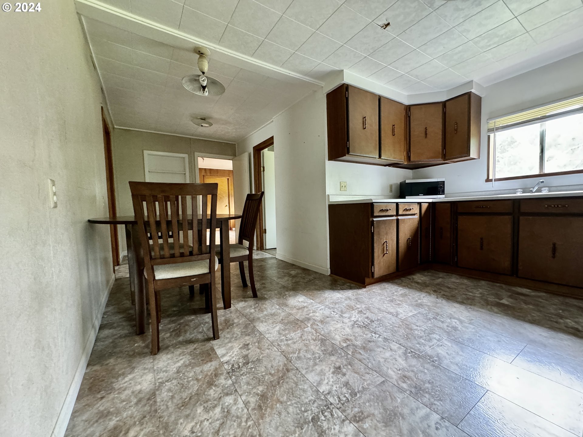 210 Winter Green Drive Riddle, OR 97469 - Photo 16 of 30 a view of kitchen with window and furniture