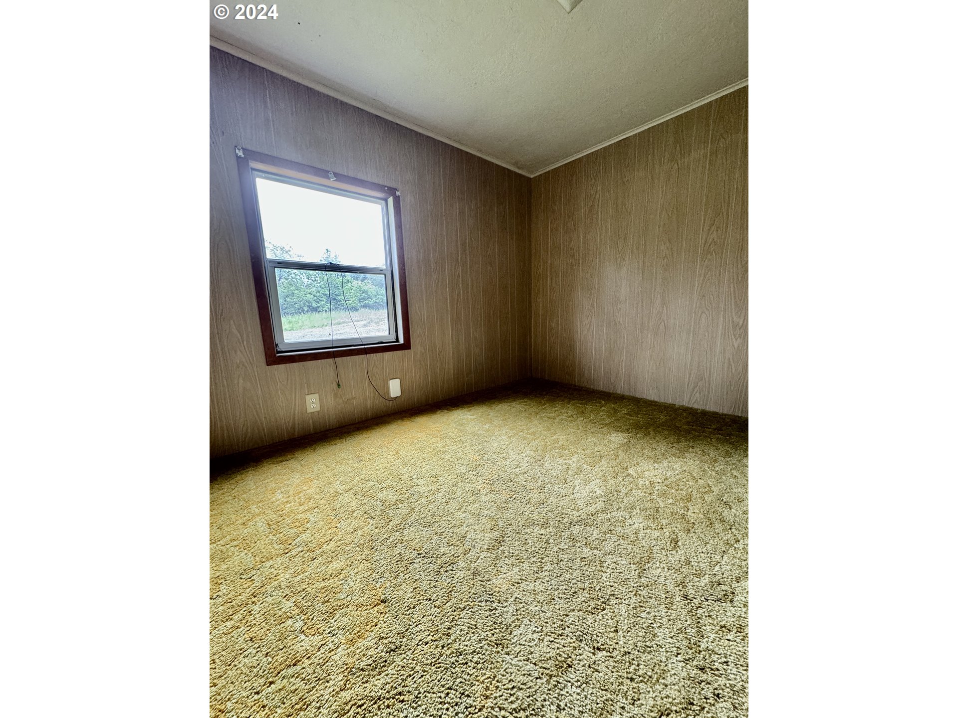 210 Winter Green Drive Riddle, OR 97469 - Photo 21 of 30 a view of an empty room with a window
