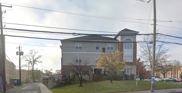 a view of a house with a yard and potted plants