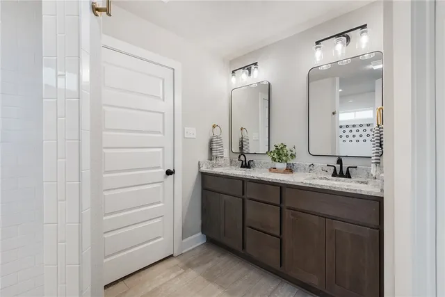 a bathroom with a double vanity sink and mirror