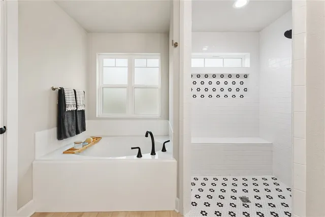 a bathroom with a bathtub and a shower