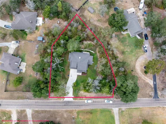 an aerial view of a house with a yard and garden