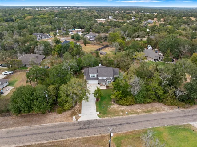 an aerial view of residential house with green space