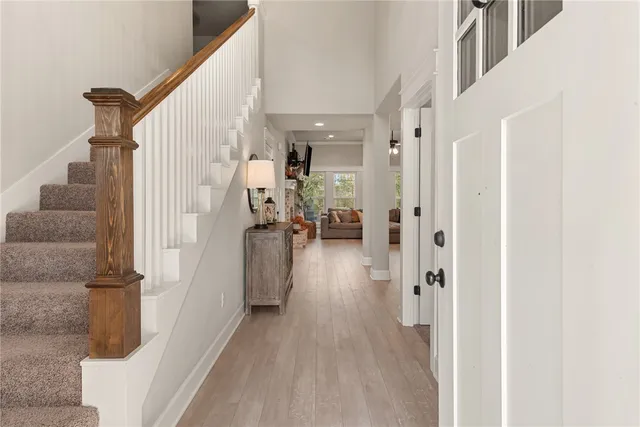a view of a hallway with wooden floor and staircase