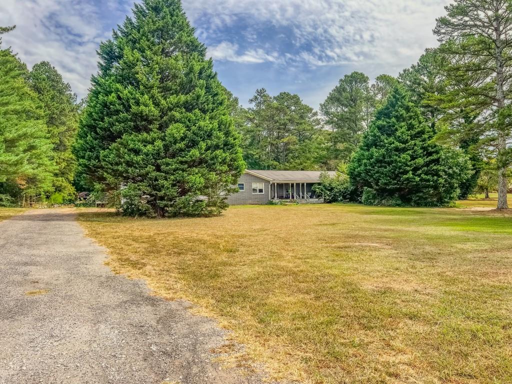 1142 Harbins Road Dacula, GA 30019 - Photo 18 of 18 a view of a swimming pool with an outdoor seating and a yard