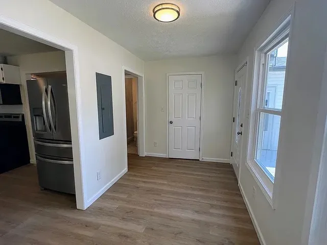 a view of a refrigerator in kitchen and window