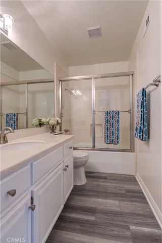 a bathroom with a shower sink and toilet