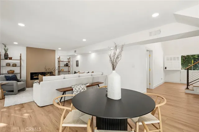 a living room with furniture a wooden floor and a chandelier