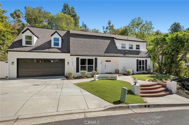 a front view of a house with a yard table and chairs