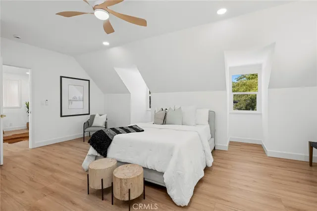 a bedroom with a bed and wooden floor