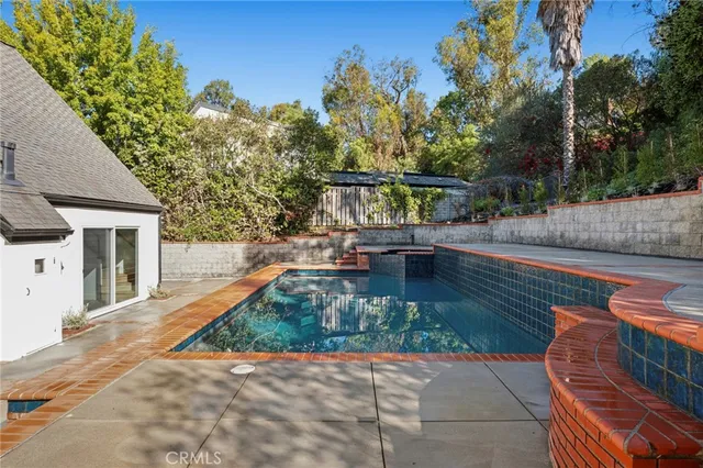 a view of yard from deck with patio