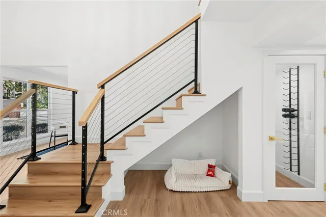 a view of entryway and hall with wooden floor