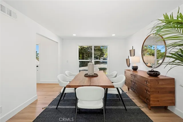 a dining room with furniture a rug and a window