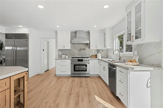 a kitchen with a stove a sink and a refrigerator