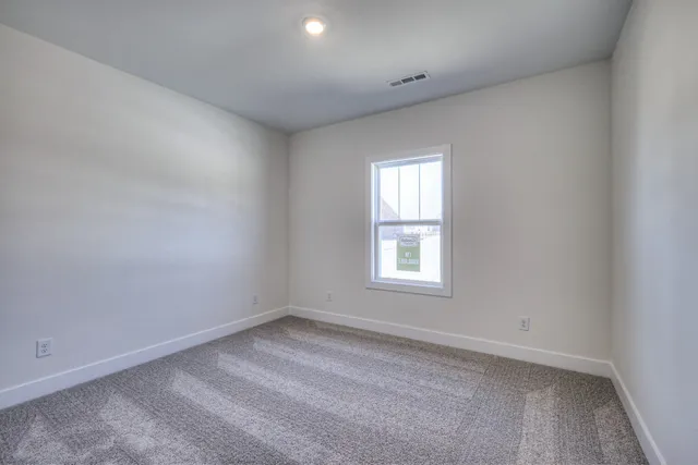 a bathroom with a bathtub shower sink vanity mirror and toilet