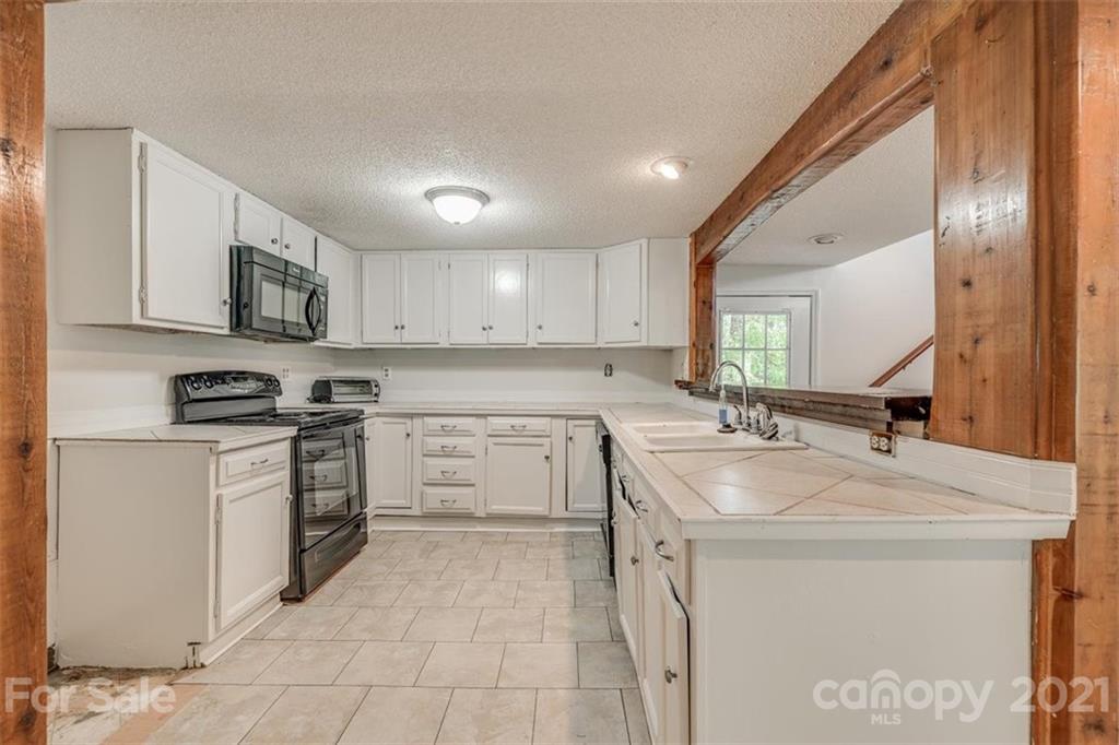 5349 Charlotte Highway Lake Wylie, SC 29710 - Photo 15 of 35 a kitchen with a sink stove and microwave