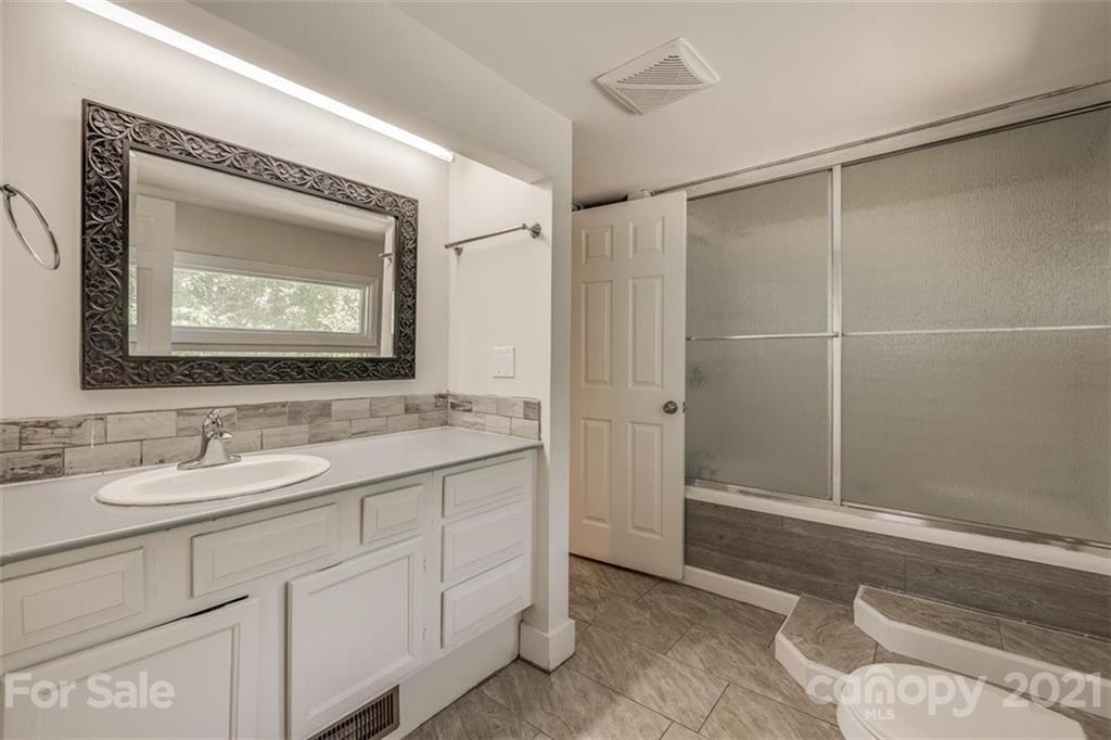5349 Charlotte Highway Lake Wylie, SC 29710 - Photo 18 of 35 a bathroom with a sink and a mirror