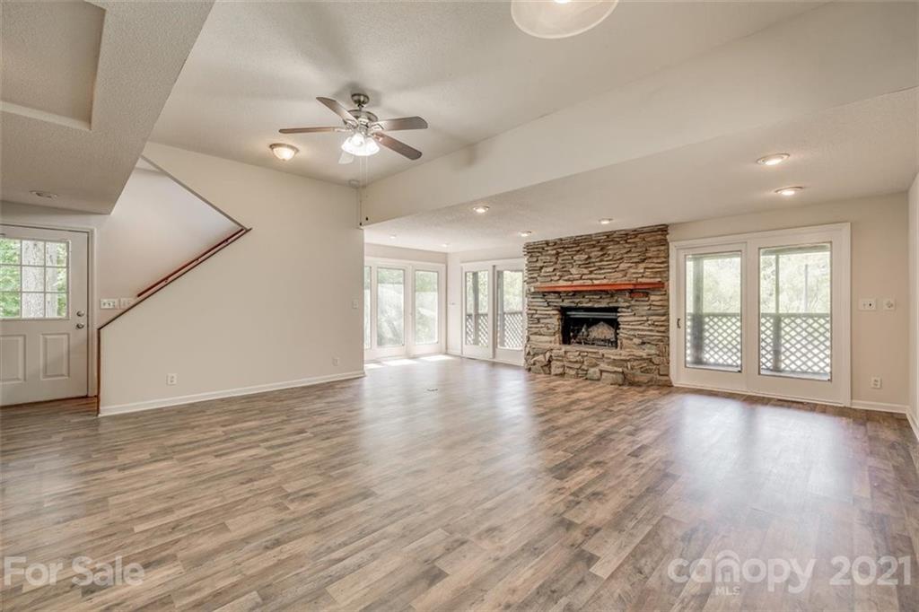 5349 Charlotte Highway Lake Wylie, SC 29710 - Photo 21 of 35 an empty room with wooden floor fireplace and windows
