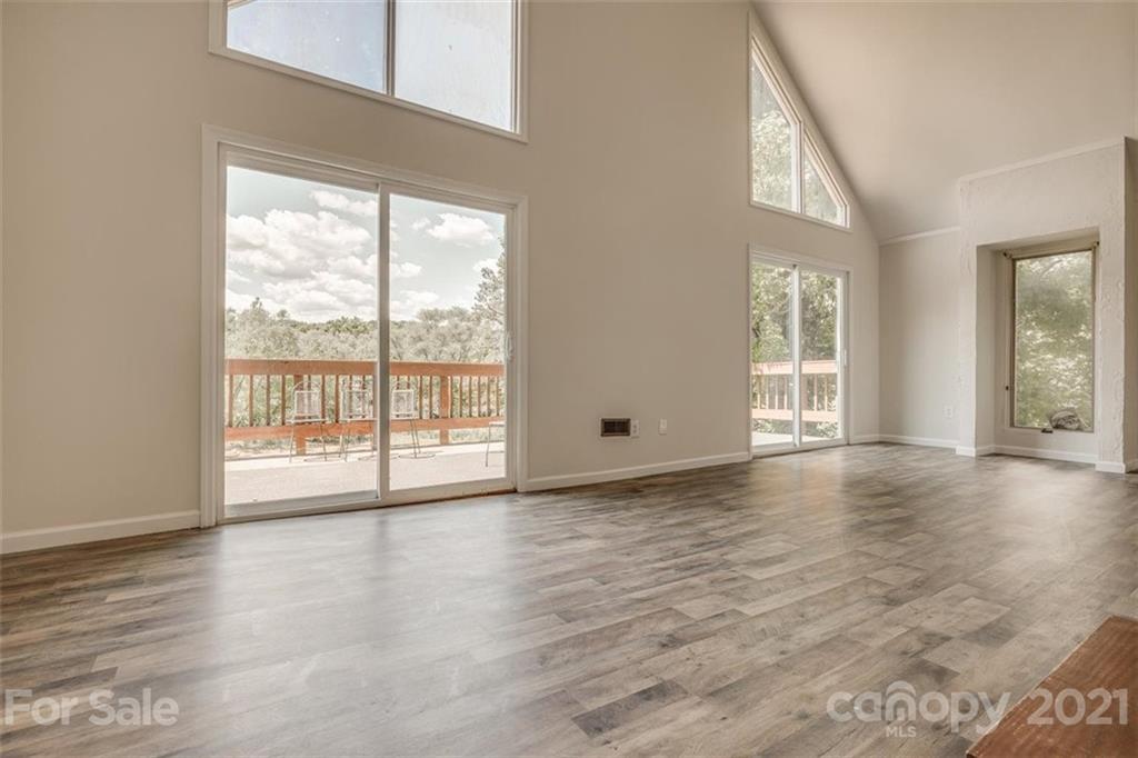 5349 Charlotte Highway Lake Wylie, SC 29710 - Photo 25 of 35 a view of an empty room with wooden floor and a window
