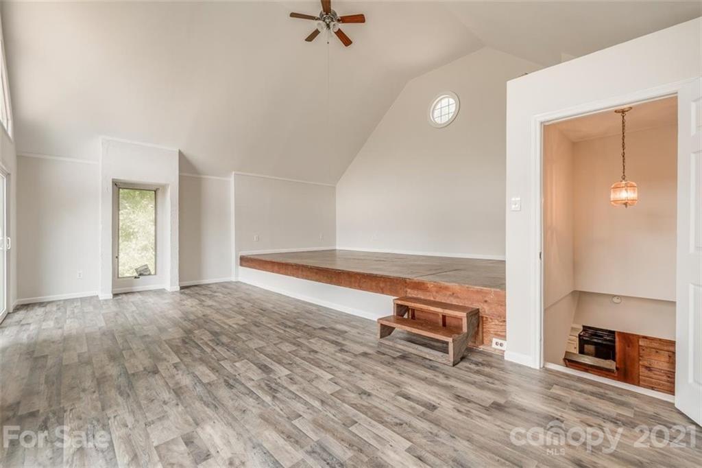 5349 Charlotte Highway Lake Wylie, SC 29710 - Photo 26 of 35 a view of an empty room with wooden floor and a fireplace