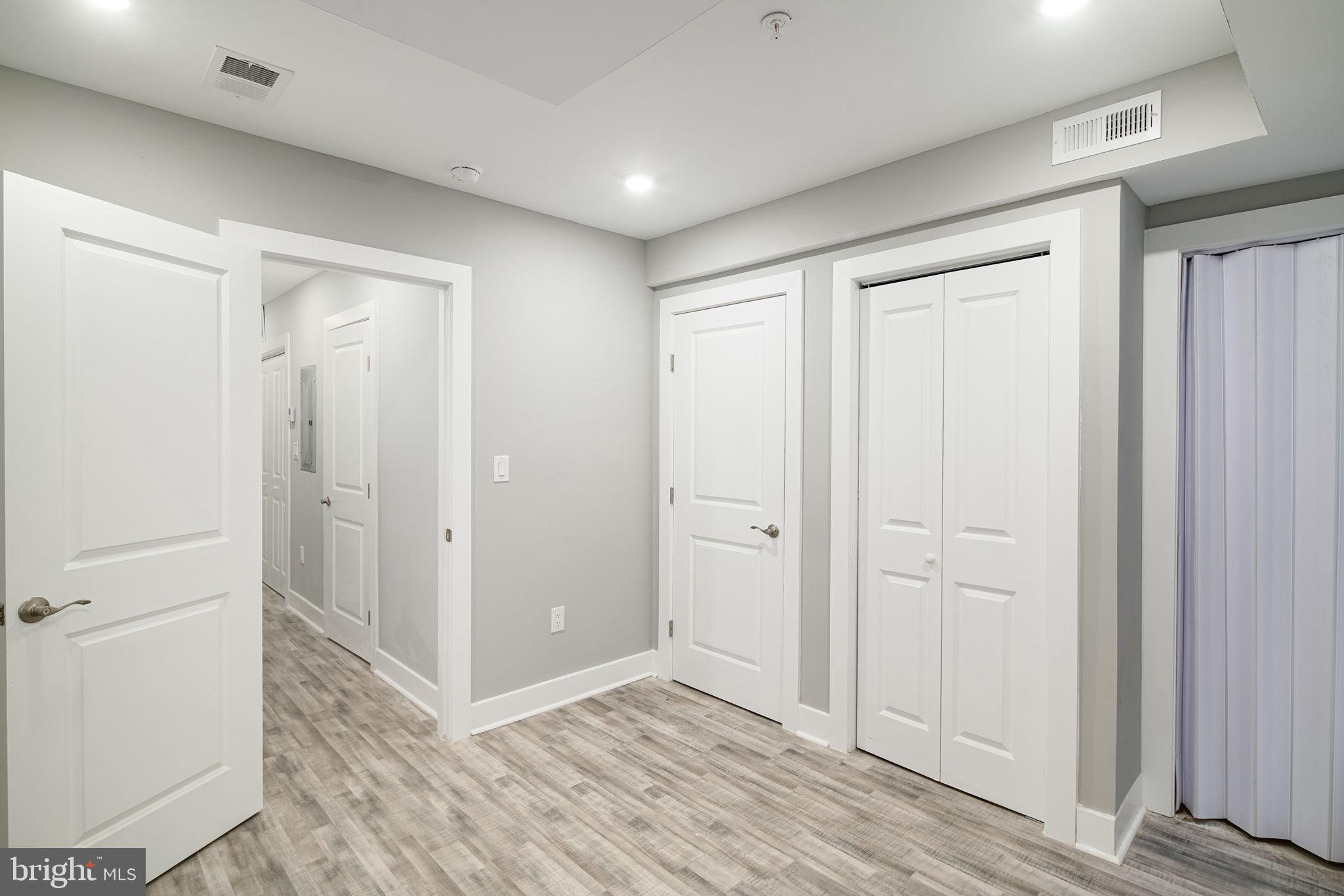 1443 North 8th Street, Unit 2 Philadelphia, PA 19122 - Photo 12 of 18 an empty room with closet and wooden floor