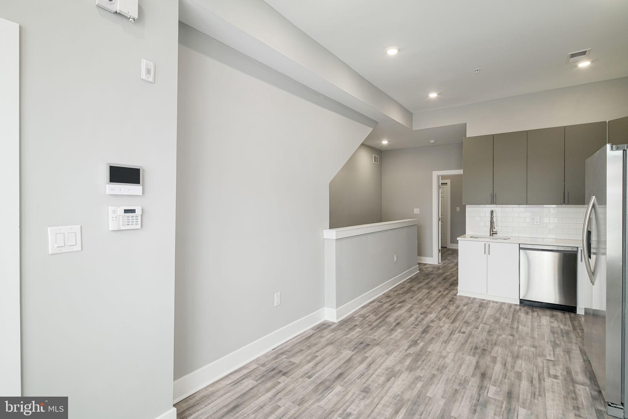 1443 North 8th Street, Unit 2 Philadelphia, PA 19122 - Photo 5 of 18 a kitchen with a refrigerator and a stove top oven