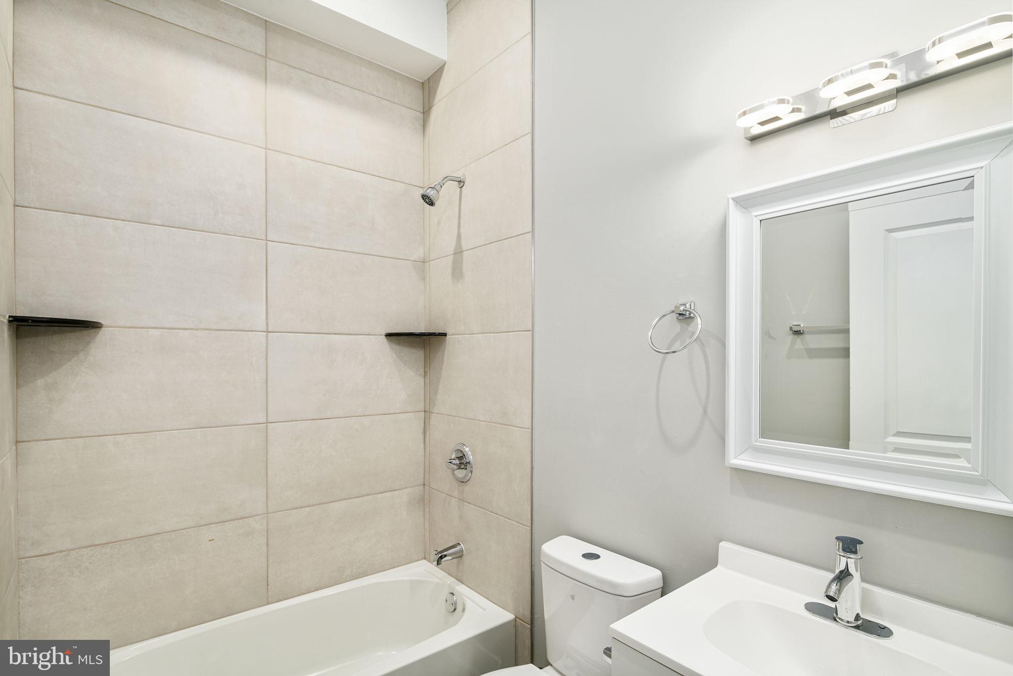 1443 North 8th Street, Unit 2 Philadelphia, PA 19122 - Photo 9 of 18 a bathroom with a sink toilet and shower