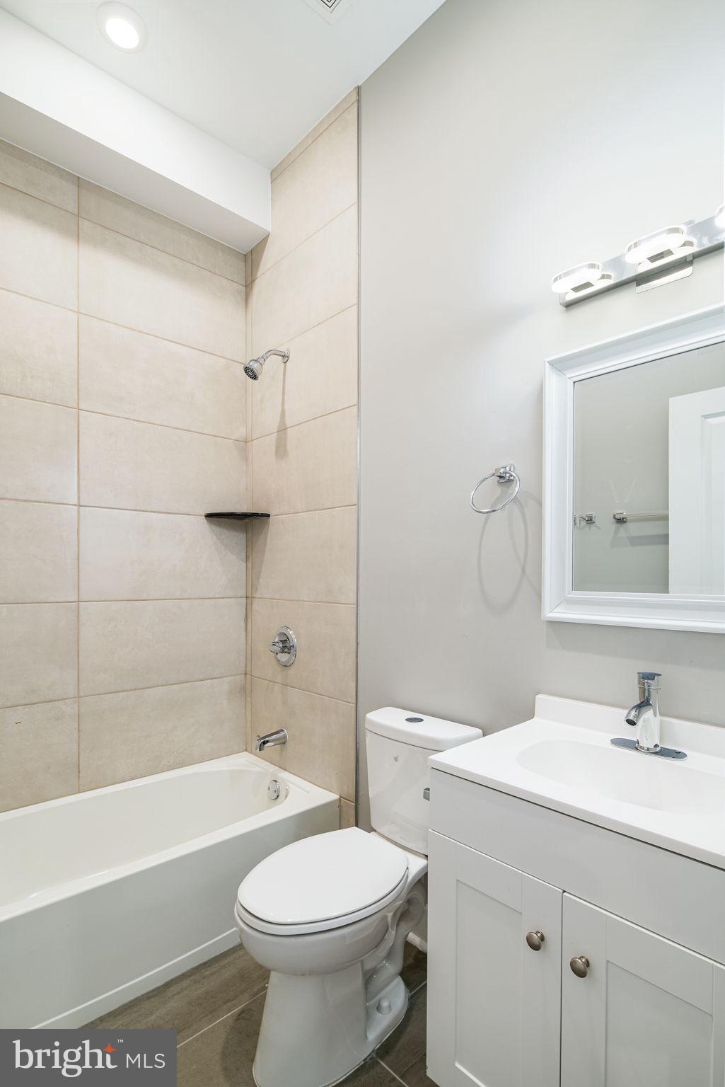 1443 North 8th Street, Unit 2 Philadelphia, PA 19122 - Photo 10 of 18 a bathroom with a sink a toilet and a bathtub