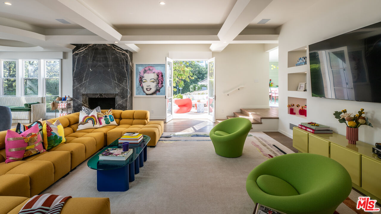 661 Doheny Road Beverly Hills, CA 90210 - Photo 14 of 33 a living room with furniture and a fireplace