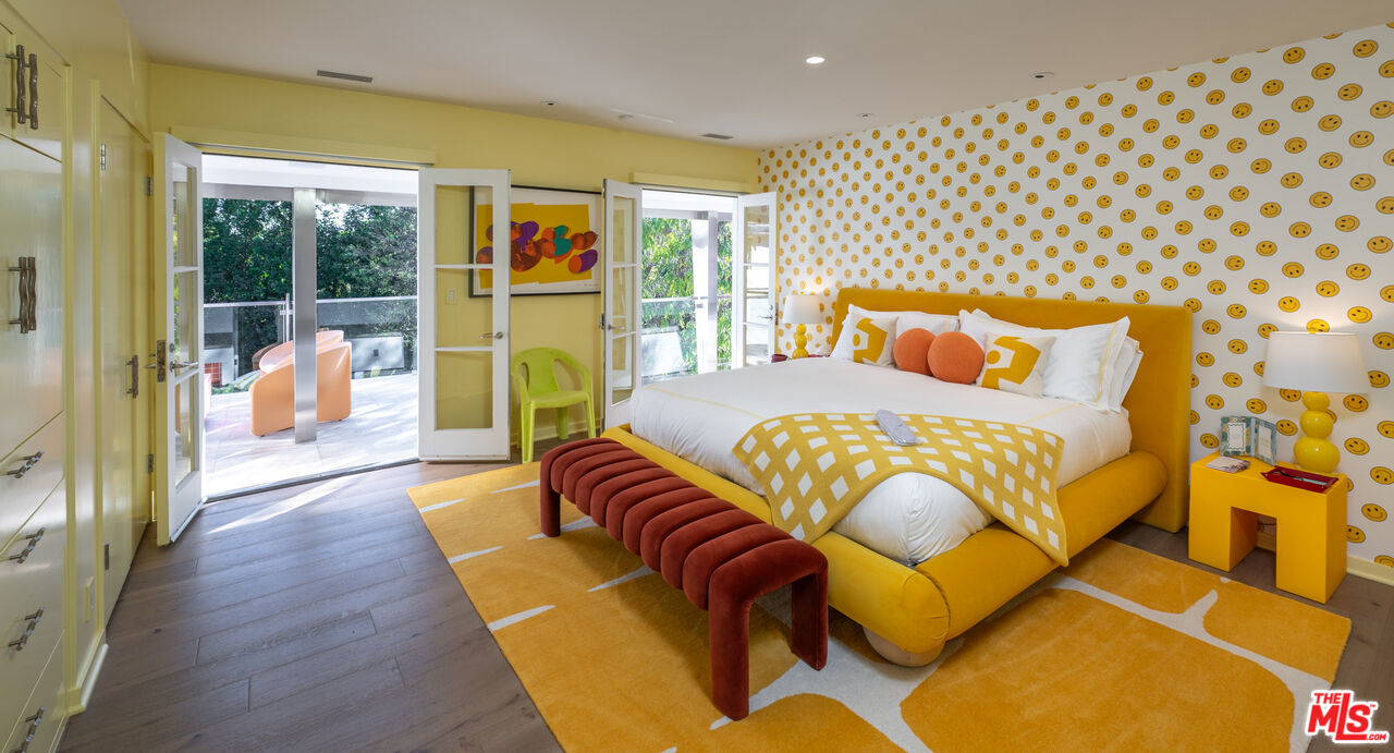 661 Doheny Road Beverly Hills, CA 90210 - Photo 17 of 33 a bedroom with a bed and wooden floor