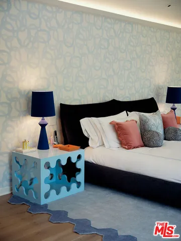 a bedroom with a bed and lamp