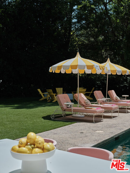 661 Doheny Road Beverly Hills, CA 90210 - Photo 27 of 33 a view of a house with backyard water fountain and sitting area