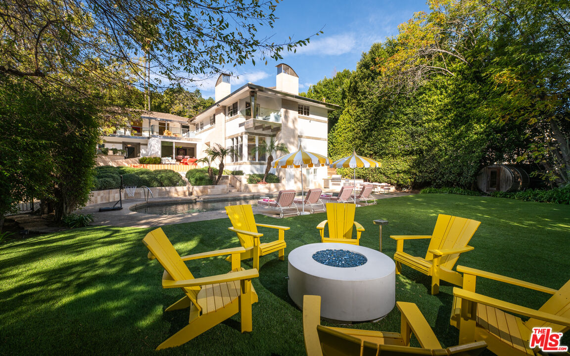 661 Doheny Road Beverly Hills, CA 90210 - Photo 33 of 33 a swimming pool with outdoor seating and yard