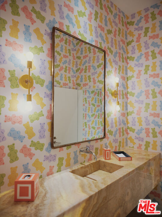 661 Doheny Road Beverly Hills, CA 90210 - Photo 5 of 28 a bathroom with a sink and a mirror