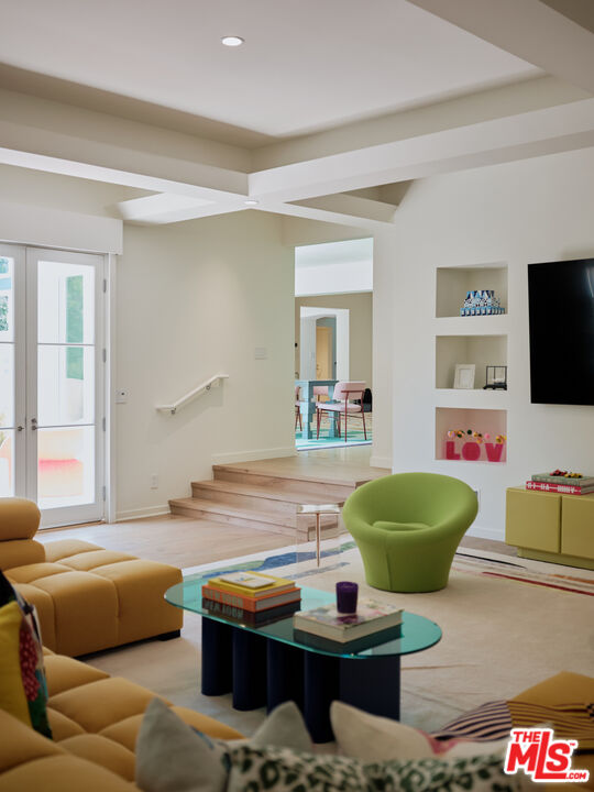 661 Doheny Road Beverly Hills, CA 90210 - Photo 9 of 28 a living room with furniture and a flat screen tv