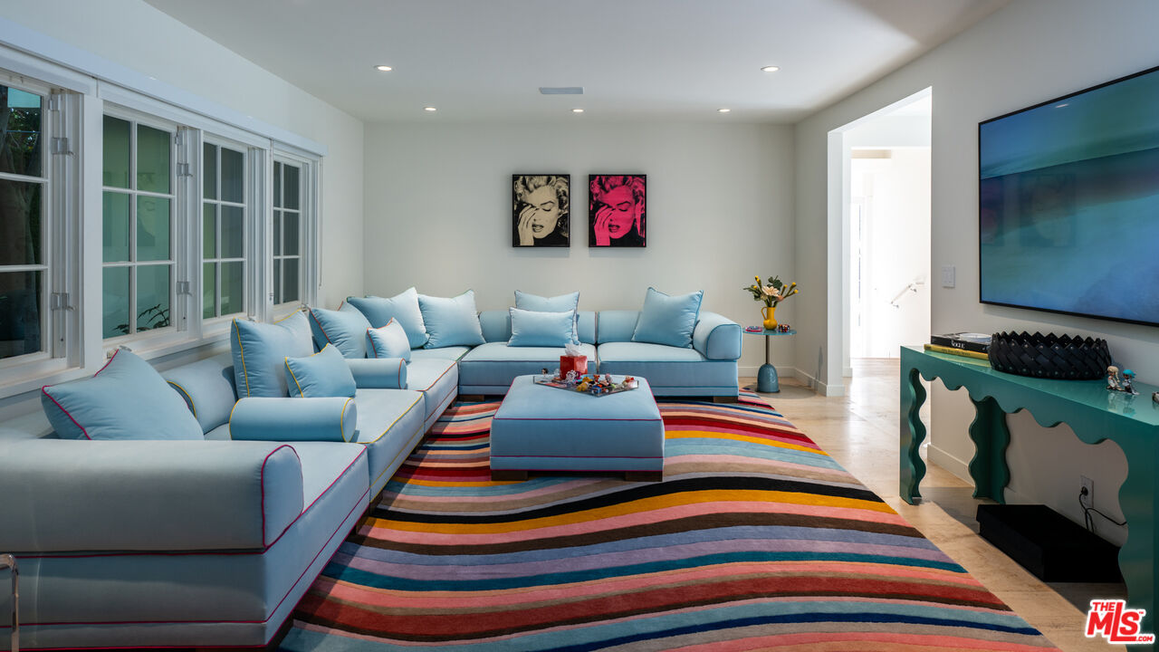 661 Doheny Road Beverly Hills, CA 90210 - Photo 10 of 33 a living room with furniture and a flat screen tv