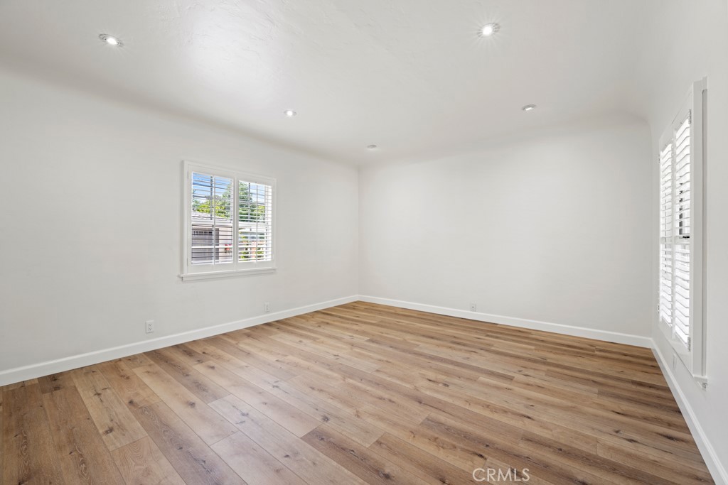 731 North Beachwood Drive Burbank, CA 91506 - Photo 14 of 53 an empty room with wooden floor and windows
