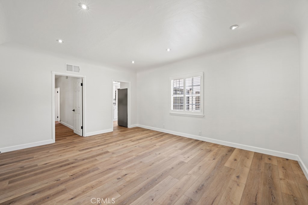 731 North Beachwood Drive Burbank, CA 91506 - Photo 16 of 53 a view of an empty room with wooden floor and a window