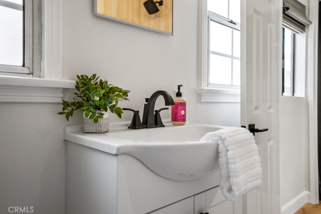 731 North Beachwood Drive Burbank, CA 91506 - Photo 19 of 53 a bathroom with a sink a vanity and a mirror
