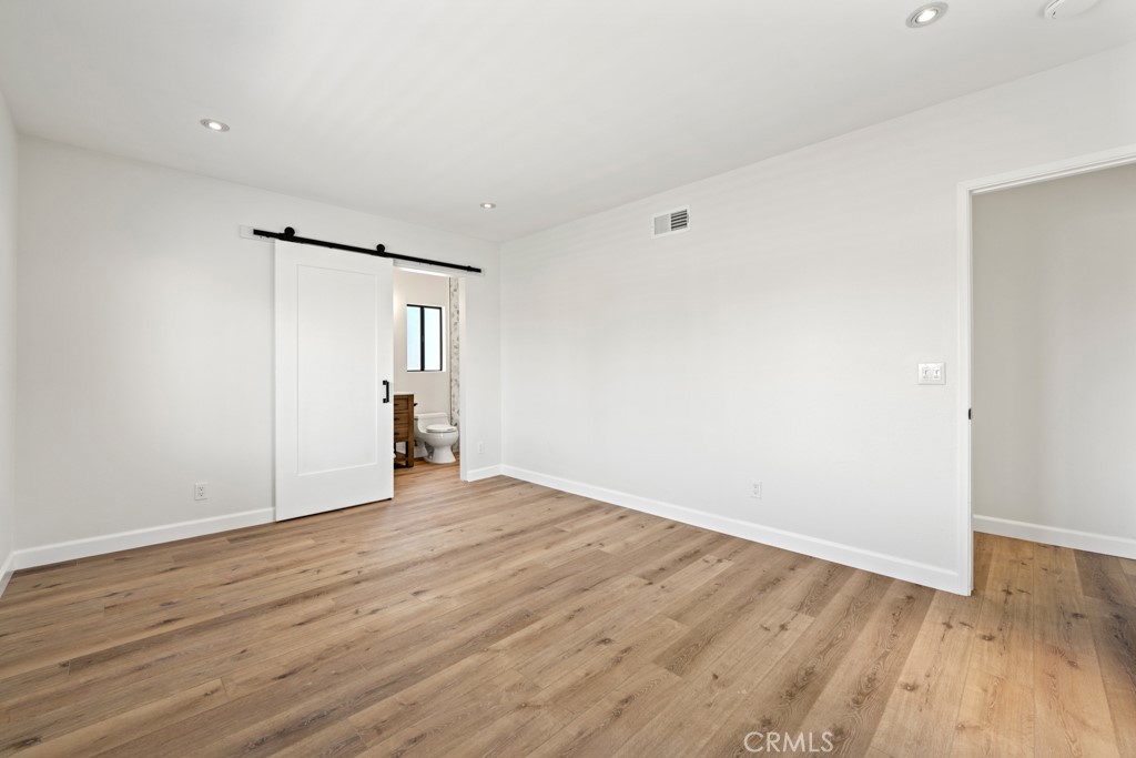 731 North Beachwood Drive Burbank, CA 91506 - Photo 34 of 53 a view of an empty room with wooden floor and a window