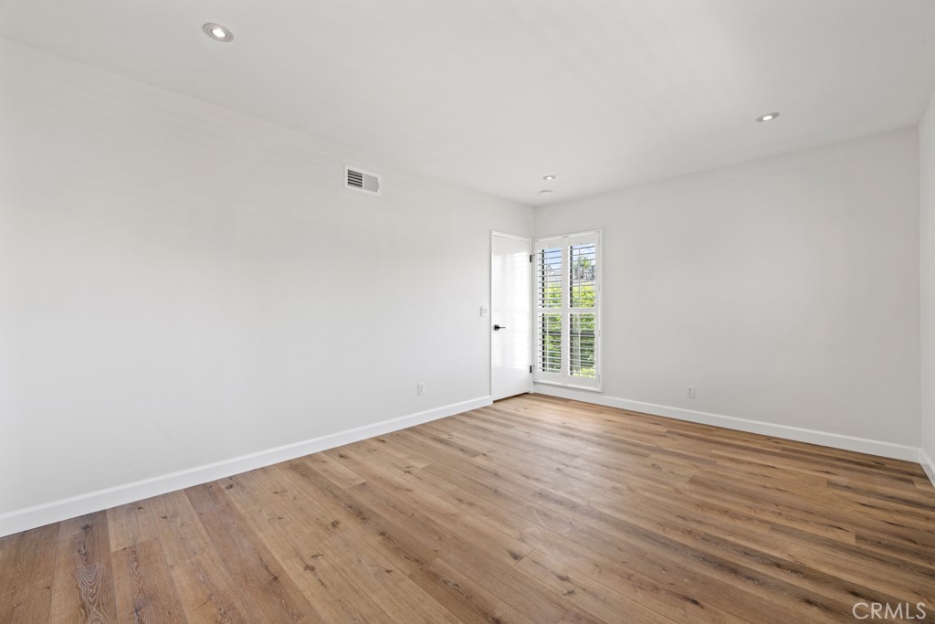 731 North Beachwood Drive Burbank, CA 91506 - Photo 36 of 53 a view of an empty room with wooden floor and a window