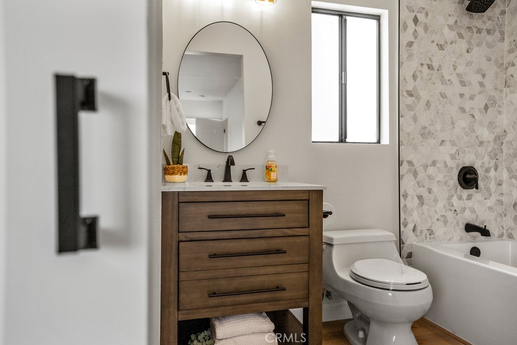 731 North Beachwood Drive Burbank, CA 91506 - Photo 39 of 53 a bathroom with a toilet a sink and a mirror