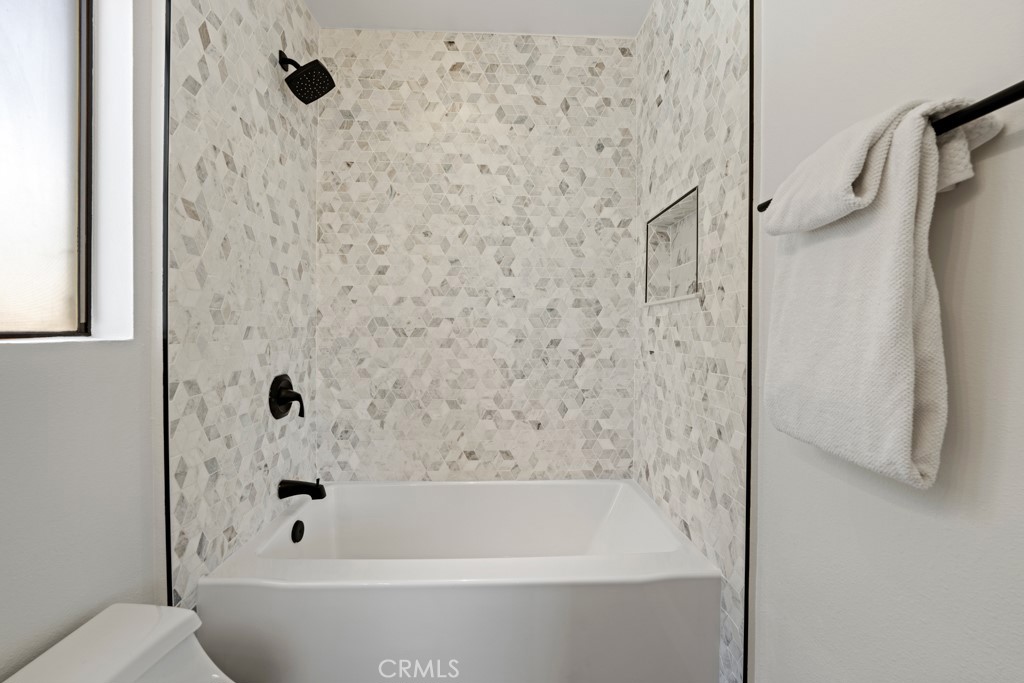 731 North Beachwood Drive Burbank, CA 91506 - Photo 40 of 53 a bathroom with a bathtub and a shower