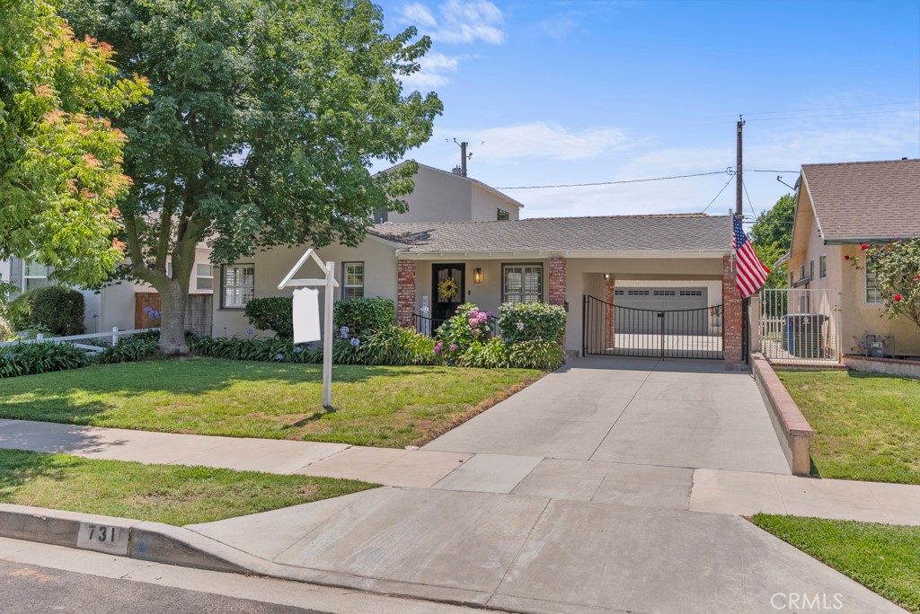 731 North Beachwood Drive Burbank, CA 91506 - Photo 48 of 53 a front view of a house with a yard and garage